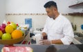 Lifestyle portrait of Asian home cook man or professional chief preparing for cooking and making Japanese sushi rolls wearing Royalty Free Stock Photo