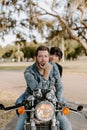 Portrait of Attractive Good Looking Young Modern Trendy Fashionable Guy Girl Couple Riding on Green Motorcycle Cruiser Old School Royalty Free Stock Photo