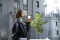 Lifestyle portrait of beautiful fashionable young business woman, freelance, copywriter, blogger walking along the street with