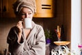 Lifestyle portrait of a beautiful young girl drinking morning coffee in her kitchen Royalty Free Stock Photo