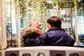 Lifestyle portrait of couple in love on the city streets with a lot of lights on background. Royalty Free Stock Photo