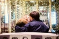 Lifestyle portrait of couple in love on the city streets with a lot of lights on background. Royalty Free Stock Photo