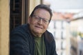 Lifestyle portrait of happy and cheerful mature man 65 to 70 years old at home balcony feeling positive and relaxed enjoying Royalty Free Stock Photo