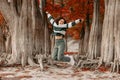 Lifestyle portrait of jumping happy woman in autumnal park Royalty Free Stock Photo