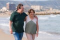 Lifestyle portrait of loving happy and sweet mature couple - senior retired husband and wife on 70s enjoying beach walk relaxed Royalty Free Stock Photo