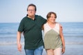 Lifestyle portrait of loving happy and sweet mature couple - senior retired husband and wife on 70s enjoying beach walk relaxed Royalty Free Stock Photo