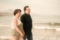 Lifestyle portrait of loving happy and sweet mature couple - senior retired husband and wife on 70s enjoying beach walk relaxed Royalty Free Stock Photo