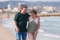 Lifestyle portrait of loving happy and sweet mature couple - senior retired husband and wife on 70s enjoying beach walk relaxed Royalty Free Stock Photo