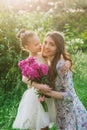 Lifestyle portrait mom and daughter are hugging in happiness in