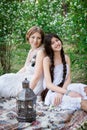 Lifestyle portrait mom and daughter outdoor in the garden.