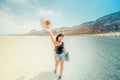 Lifestyle portrait of pretty happy girl with tanned body, wearing strawhat, smiling and sunbathing. Laughing. Royalty Free Stock Photo