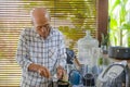 lifestyle portrait of senior happy and sweet Asian Japanese retired man cooking at home kitchen alone neat and tidy enjoying prep Royalty Free Stock Photo