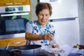 lifestyle portrait of senior happy and sweet Asian Japanese retired woman cooking at home kitchen alone neat and tidy Royalty Free Stock Photo