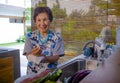 lifestyle portrait of senior happy and sweet Asian Japanese retired, woman cooking at home kitchen washing the dishes Royalty Free Stock Photo