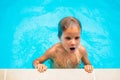 Lifestyle portrait serious boy swim in pool, after hard train tired, emerge up on edge hold, bright blue water. Facial Royalty Free Stock Photo