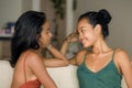 Lifestyle portrait of two young happy and relaxed Asian girlfriends having fun talking laughing and gossiping at home sofa couch s Royalty Free Stock Photo