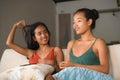 Lifestyle portrait of two young happy and relaxed Asian girlfriends having fun talking laughing and gossiping at home sofa couch s Royalty Free Stock Photo