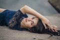 Lifestyle portrait of a woman brunette on background of the lake lying in sand on a cloudy day. Romantic, gentle, mystical Royalty Free Stock Photo