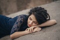 Lifestyle portrait of a woman brunette on background of the lake lying in sand on a cloudy day. Romantic, gentle, mystical Royalty Free Stock Photo