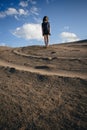 Lifestyle portrait of a woman brunettes Bouncing in the sand a clear day. Romantic, gentle, mystical, pensive image of a girl Royalty Free Stock Photo