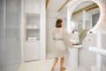 Lifestyle portrait of a woman at modern and bright bathroom interior Royalty Free Stock Photo