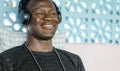 Lifestyle portrait of young attractive and happy cool black African American man smiling cheerful listening to music on yellow Royalty Free Stock Photo