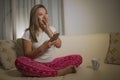 Young attractive happy and relaxed student girl enjoying homey sitting at living room sofa couch using internet social media or Royalty Free Stock Photo