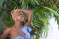 Lifestyle portrait of young attractive and joyful black afro american woman smiling happy posing cheerful at home terrace with gre Royalty Free Stock Photo