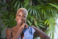 Lifestyle portrait of young attractive and joyful black afro american woman smiling happy posing cheerful at home terrace with gre Royalty Free Stock Photo