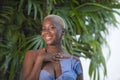 Lifestyle portrait of young attractive and joyful black afro american woman smiling happy posing cheerful at home terrace with gre Royalty Free Stock Photo