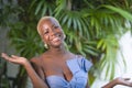 Lifestyle portrait of young attractive and joyful black afro american woman smiling happy posing cheerful at home terrace with gre Royalty Free Stock Photo