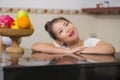 Lifestyle portrait of young beautiful and happy Asian Chinese woman posing relaxed at home kitchen smiling cheerful and sweet Royalty Free Stock Photo