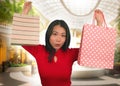 Lifestyle portrait of young beautiful and happy Asian Korean woman holding shopping bags at modern shopping mall smiling excited Royalty Free Stock Photo