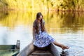 Lifestyle portrait of young beautiful woman sitting at motorboat. girl having fun at boat on the water