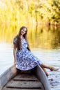 Lifestyle portrait of young beautiful woman sitting at motorboat. girl having fun at boat on the water Royalty Free Stock Photo