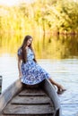 Lifestyle portrait of young beautiful woman sitting at motorboat. girl having fun at boat on the water