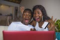 Lifestyle portrait of young happy and attractive black African American couple enjoying at home using credit card and laptop Royalty Free Stock Photo