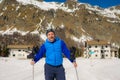 Lifestyle portrait of young happy and attractive man doing cross country ski enjoying winter holidays on Swiss Alps having fun on Royalty Free Stock Photo