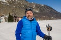 Lifestyle portrait of young happy and attractive man doing cross country ski enjoying winter holidays on Swiss Alps having fun on Royalty Free Stock Photo