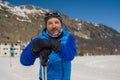 Lifestyle portrait of young happy and attractive man doing cross country ski enjoying winter holidays on Swiss Alps having fun on Royalty Free Stock Photo