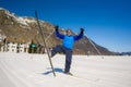 Lifestyle portrait of young happy and attractive man doing cross country ski enjoying winter holidays on Swiss Alps having fun on Royalty Free Stock Photo