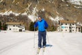 Lifestyle portrait of young happy and attractive man doing cross country ski enjoying winter holidays on Swiss Alps having fun on Royalty Free Stock Photo