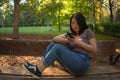 Lifestyle portrait of young happy and beautiful Asian Chinese woman using internet app on mobile phone relaxed and cheerful at Royalty Free Stock Photo