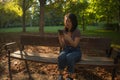 Lifestyle portrait of young happy and beautiful Asian Korean woman using internet app on mobile phone relaxed and cheerful at city Royalty Free Stock Photo