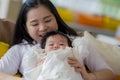 Lifestyle portrait of young happy and cute Asian Korean woman playing and holding sweet adorable baby girl together in mother and Royalty Free Stock Photo