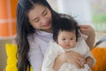 Lifestyle portrait of young happy and cute Asian Korean woman playing and holding sweet adorable baby girl together in mother and Royalty Free Stock Photo