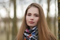 Lifestyle portrait of young and pretty adult woman with gorgeous long hair posing in city park with shallow depth of field Royalty Free Stock Photo