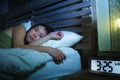 Young pretty sad and depressed Asian Korean woman awake having insomnia disorder lying in bed sleepless suffering anxiety depressi Royalty Free Stock Photo