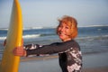 Young beautiful and happy surfer girl holding yellow surf board smiling cheerful enjoying summer holidays in tropical beach w