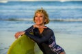 Lifestyle portrait of young beautiful and happy surfer woman holding yellow surf board smiling cheerful enjoying summer holid Royalty Free Stock Photo